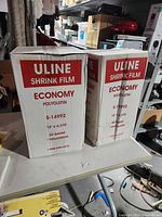 Front view of both Uline Economy Shrink Film cartons showing branding and specifications