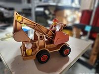 Side view of Fisher-Price excavator with two Little People figures