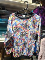 Front view of patterned sweater on hanger