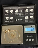 Bracelet and earrings on scale showing 1.86 g