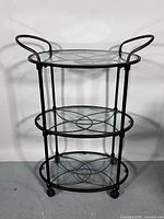 Front view of bar cart showing three tiers and casters