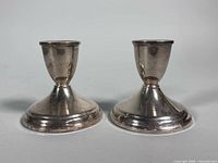 Front view of both Duchin sterling candleholders