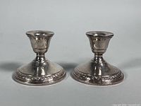 Front view of both sterling silver weighted candleholders