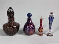 Group shot of all four art glass perfume bottles