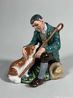 Front view of Royal Doulton figurine showing man with dog and shepherd’s crook