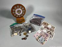 Entire lot showing clock, coin bags and banknotes