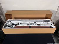 factory box opened showing all components in foam inserts