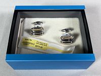 Cufflinks in presentation box with retail tag visible