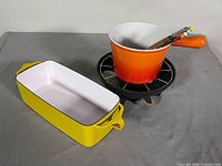 Dansk Kobenstyle baker beside Le Creuset fondue pot on stand
