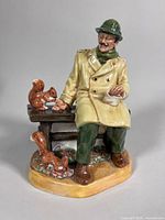 Front view of Royal Doulton Lunchtime HN2485 figurine showing man, bench, squirrels
