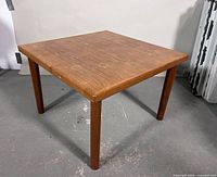 Three-quarter view of full wooden square end table showing legs and top