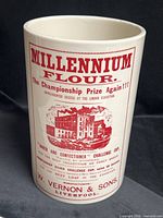 Full view of ceramic advertising canister showcasing graphics
