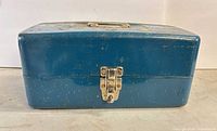 Closed blue metal toolbox front view showing latch