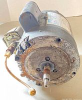 Front view of motor showing shaft, corrosion and attached pressure switch