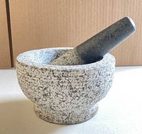 Granite mortar and pestle set angled view