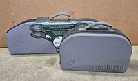 two grey WindRiver carry cases, larger marked Volleyball & Badminton Set, smaller for bocce
