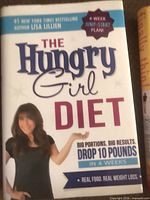 Front cover of The Hungry Girl Diet hardcover book beside spine of Finally Thin!
