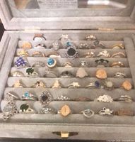 Entire open display case showing multiple rows of rings