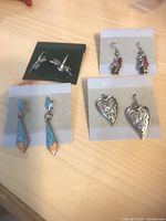 Six pairs including dragonfly studs, geometric turquoise drops, silver hearts, purple wing drops