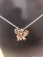 Silver-tone chain with multicolored enamel elephant pendant and small charm