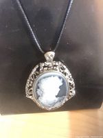 Front view of extra-large cameo pendant on black cord