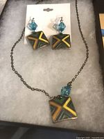 Necklace and matching earrings with square multicolor enamel pendants and aqua beads displayed in box