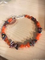 Orange and tan chip-stone bracelet showing clasp and bead details