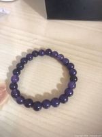 Deep-purple stretch bead bracelet shown flat