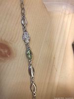 Silver-tone bracelet with marquise light green stone and clear rhinestone station