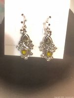 Front view ornate glass-inlay drop earrings on card