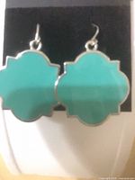 Front view of turquoise enamel quatrefoil earrings
