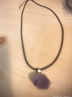 Single necklace showing pendant, cord, and clasp