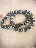 Pair of blue-green crystal bead stretch bracelets with gold-tone spacers