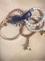 Assorted gold-tone, faux pearl and beaded stretch bracelets with charms