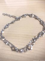 Multi-strand silver-plated bracelet with extender displayed on tabletop