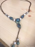 Blue and white bead Y-style necklace on brown cord