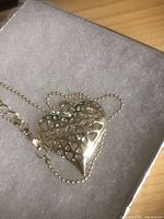 Silver-tone openwork heart pendant with rhinestones in box