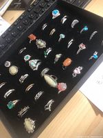 Display tray holding multiple silver and gold tone rings