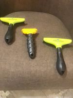 Three Furminator deshedding tools on chair