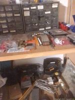 Overview of drawer organizers, drill bits and small tools on shelf