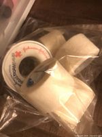 three rolls of Johnson & Johnson adhesive medical tape in plastic bag