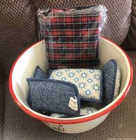Hallmark popcorn bowl filled with blue patterned sponges and unopened plaid pie-crust makers