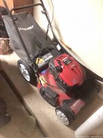 Full view of mower showing deck, handle, rear bag