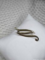 front view of brooch on cushion