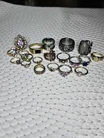 All 18 rings displayed on fabric surface for count and style overview