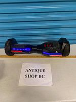 Full view of hoverboard powered on showing LEDs and tires