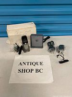 All components laid out: handset on cradle, base station, camera, two adapters, cables