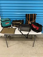 Group shot of six tool and utility bags on table