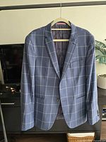 Full front view of blazer on hanger showing pattern and overall condition