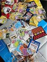 Overview of mixed Pokémon cards, booklets, playmat, damage counters and GX marker